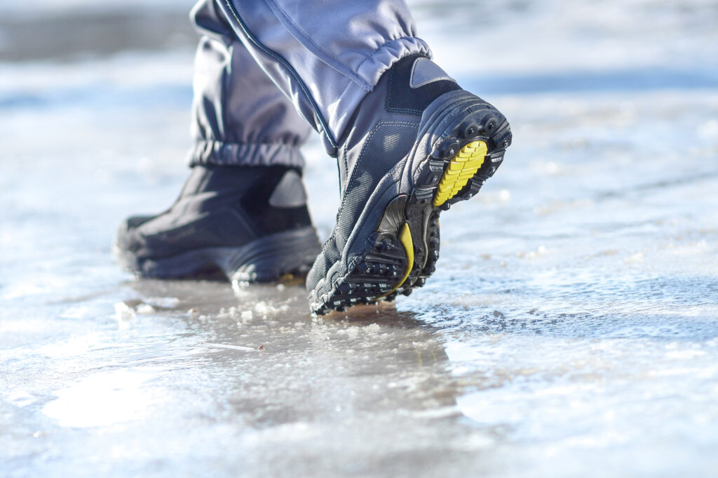 Walking on ice with winter boots for a safe winter