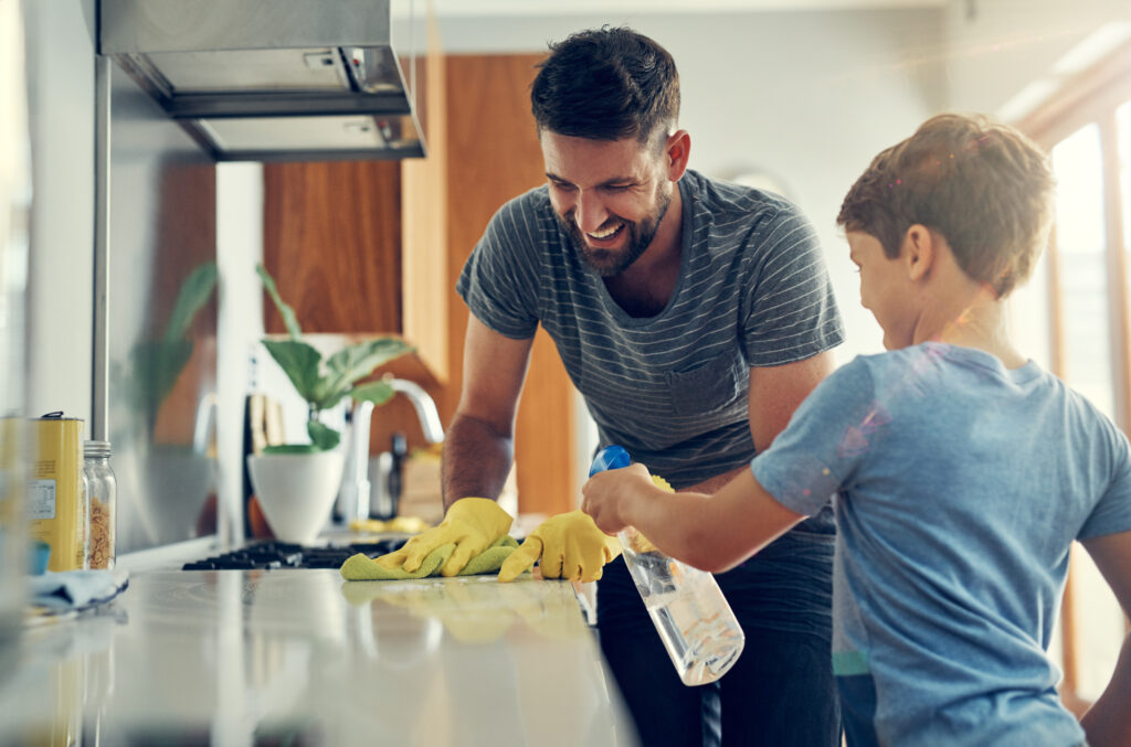 Dad and son cleaning a counter.