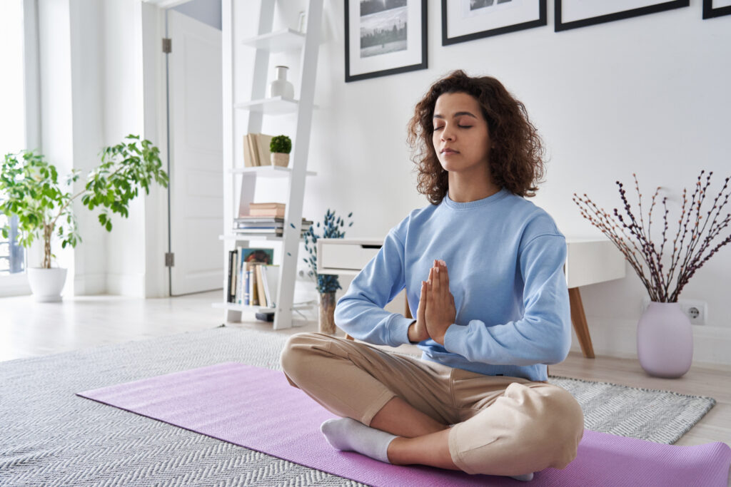 Woman meditating in home for mental health